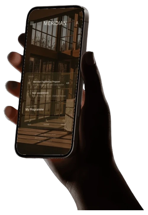 A photographic hand holding a phone displaying the Meridian Health app home screen