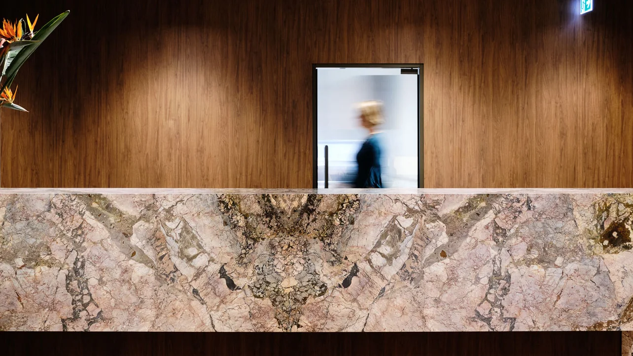 The marble reception desk and timber wall at our Brenan Place practice.