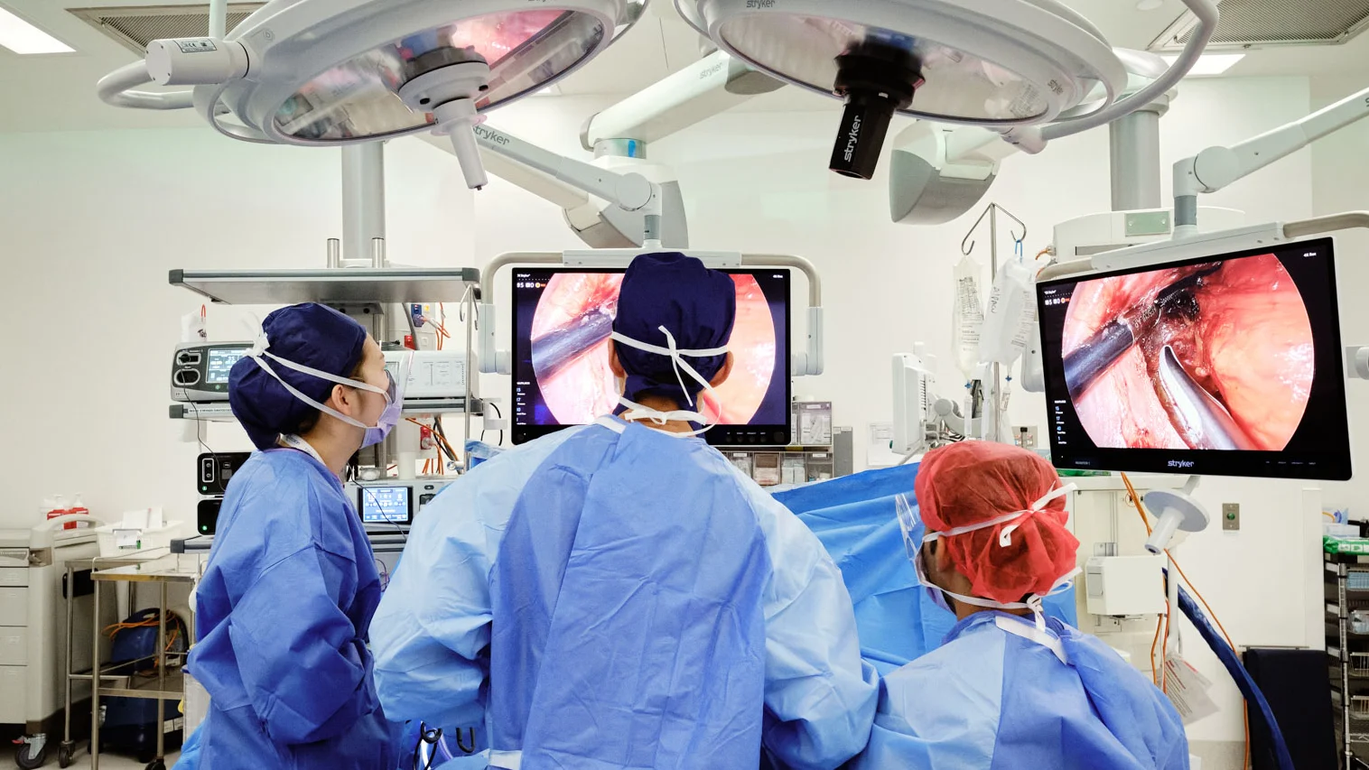 The surgical team performing laparoscopic surgery in an operating theatre